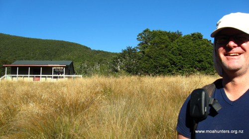 Mighty Moa Hunter Chris in front of Speargrass hut.
